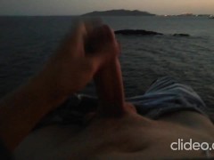 Skinny guy masturbates on a cliff during a sunset in Ibiza