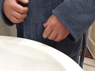 Pissing in the sink wearing a bathrobe.