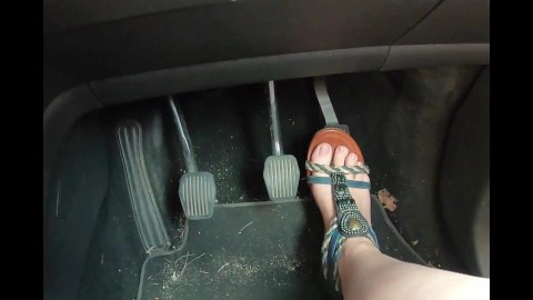 Racy seductive feet driving in revealing sandals