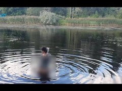 Squatting Nude On The River While Reading