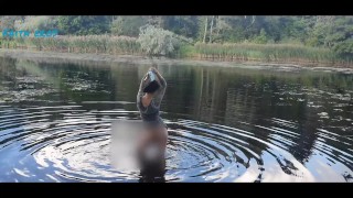 Squatting Nude On The River While Reading