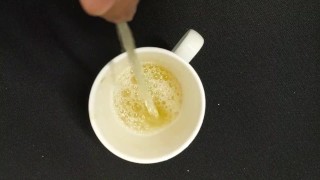 Filling up a cup with piss