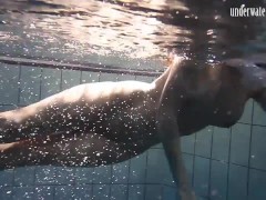 Brunette big tits teen Andrea swimming in the pool