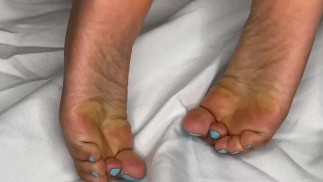 Черная девушка мастурбирует босыми ногами, демонстрируя