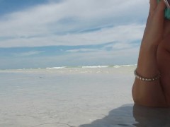 Sheer see through bikini top at the beach in the water