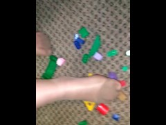 Sexy nylon feet walking on legos