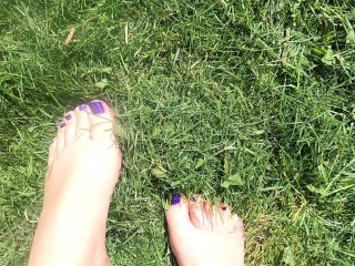 Silky soft young feet playing in freshly cut grass
