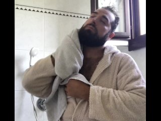 Big Italian bearded bear dry his hairy body after taking a shower after workout