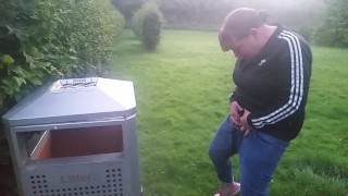 pissing into bin in the park