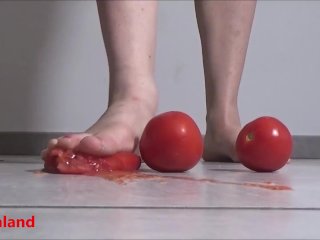 Several tomatoes are crushed under my wonderful bare feet