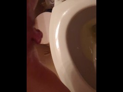 Golden stream. Peeing in toilet. Up close