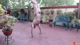 Attractive Man Practicing A Naked Handstand Outside In Front Of The Neighbors