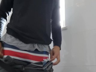 Pulling my trousers and underwear down and jerking off in the toilets