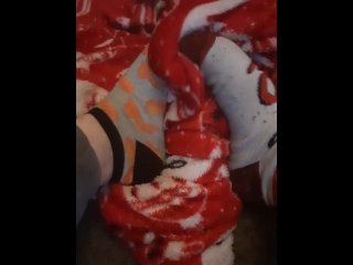 Tiny feet in mix match socks rubbing blanket