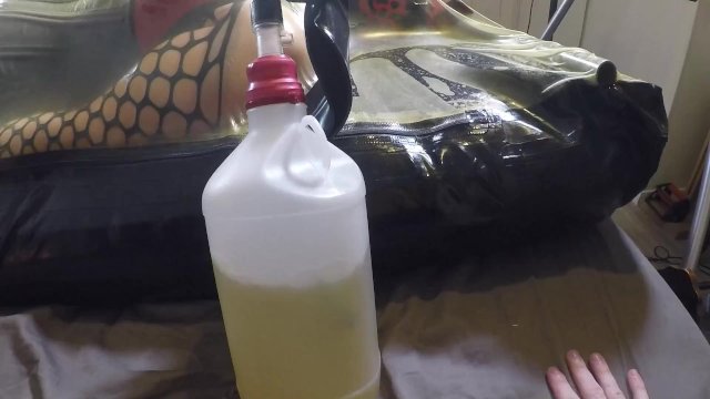 Watch Bondage Video:Miss Maskerade, enclosed in latex vacbed with gas maskand bubble bottle, full rubber bondage