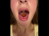 Swallowing gummy bears with open mouth