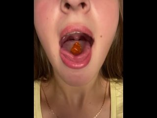 Swallowing gummy bears with open mouth
