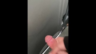 Stroking in a construction porta potty. 