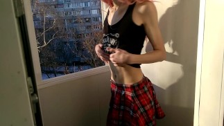 Femboy with anal plug strip on the balcony