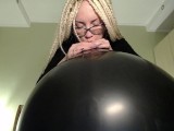 Blow big black balloon & pop with nails