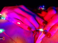 Snow Maiden brings herself to orgasm in Christmas lights