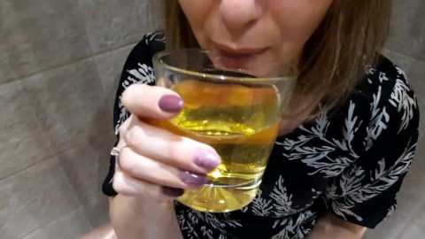 Drinking piss together from a glass. The golden drink