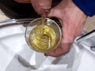 Drinking piss together from a glass. The golden drink