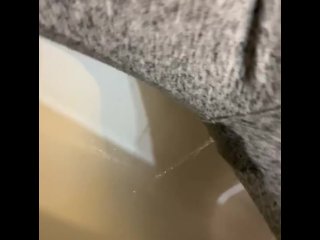 Pissing in grey sweat pants