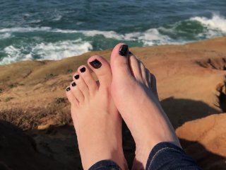Wiggling my toes at a cliff with the ocean in the background & sounds of crashing waves