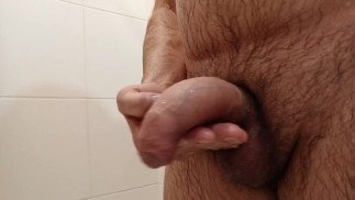 Jerking off gently in the bathroom. Saliva on the dickhead.