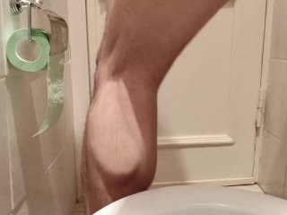 Pissing in toilet. Rear ball view