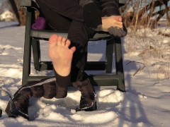 Winter Shoeplay | Dangling winter boots, showing soles and wiggling toes on snow