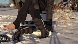 Winter Shoeplay | Dangling winter boots, showing soles and wiggling toes on snow