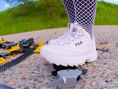 Big excavator is destroyed kicked, trampled, crushed, smashed, crushed, broken plastic car, crush