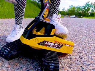 Big excavator is destroyed kicked, trampled, crushed, smashed, crushed, broken plastic car, crush