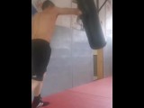 Boxing the heavy bag. Real-life bad boy and straight porn actor working out.