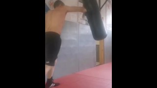 Boxing the heavy bag. Real-life bad boy and straight porn actor working out.