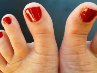 Red Nail Polish on Toes. Lady Paints her Toenails with Red Polish Regina Noir.