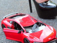 Crush of Red Audi R8 model toy car with Black Pump Stilettos