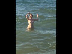 naked milf swims in the sea in front of everyone
