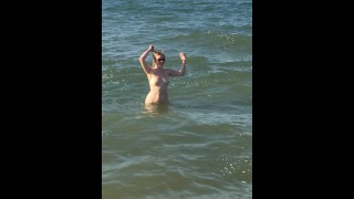 naked milf swims in the sea in front of everyone