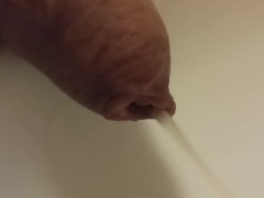 Extreme closeup pissing uncutted cock.
