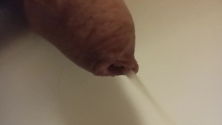Extreme closeup pissing uncutted cock.