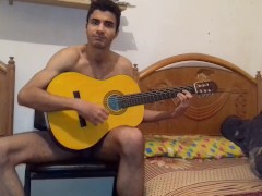 Sexy and hot naked guy training playing guitar after kissing his boy friend