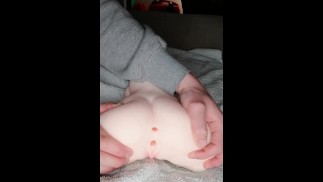 Playing and fisting with his doll in doggystyle
