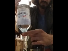opening a bottle of beer with a bottle of mineral water
