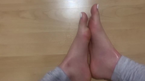 Rubbing feet together (white toenails)