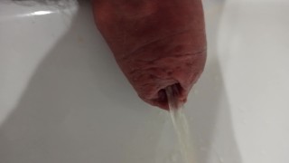 Extreme closeup, foreskin pissing