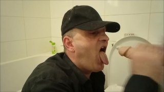 Guy sucking a suction cup dildo in the toilet