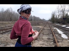 Girl undresses on the train tracks
